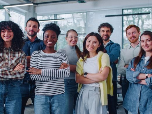 Group of employees smiling after receiving a benefits package